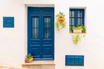 facade of white house wnd blue windows in Frigiliana, Andalousia in Spain- Malaga Province