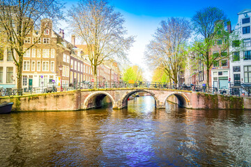Facades of old historic Houses and traditional bridge over canal water, Amsterdam, Netherlands © neirfy