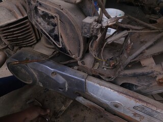 Close-up of mechanic repairing motorcycle.