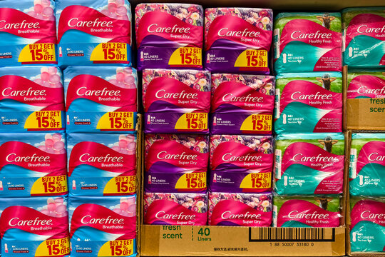Various Carefree pantyliners on supermarket shelf with promotional discounts displayed