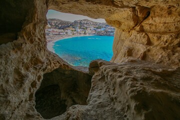 Fototapeta premium Scenic coastal town view through a rocky cave.