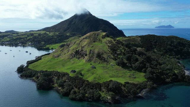 Aerial footage of the green coastal cliff at Urquharts Bay in Northland, North Island, New Zealand