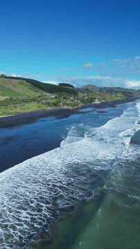 Drone shot over Awakino Beach, New Zealand with view of tranquil water on a calm day