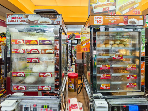Inside a 7-11 store showcasing food display cabinets