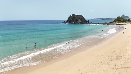 Serene beach scene with turquoise waters and rocky formations