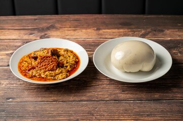 Traditional African egusi soup with pounded yam