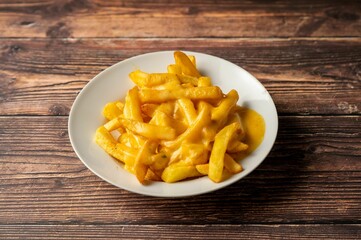 Cheesy French Fries on Rustic Table