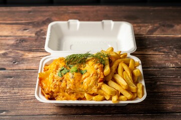 Fish and chips in a takeout container