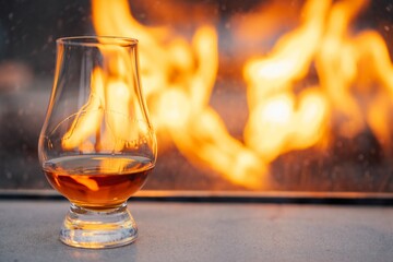 whiskey glass in front of outdoor fire pit
