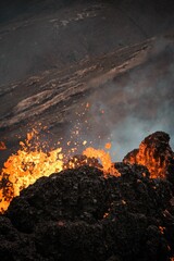 Erupting volcano with molten lava and smoke