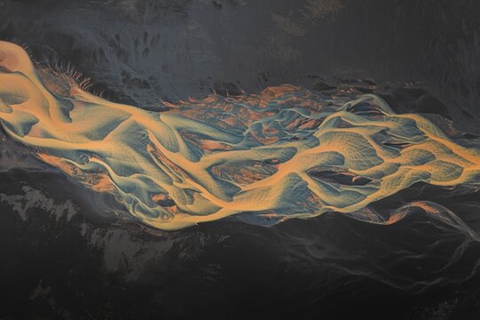 Aerial view of a vibrant river delta with intricate patterns