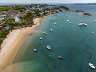 Ile de Batz Island in Bretagne, France, with yachts, greenery on beach and coastal houses