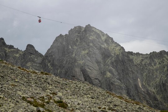 Rocky mountain landscape with cable car on a cloudy day.