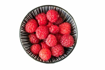 Fresh raspberries in a striped bowl