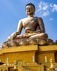 Fototapeta premium Majestic Buddha Dordenma Statue against the background of a blue sky. Bhutan