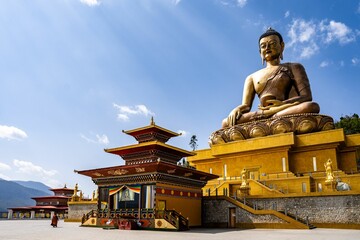 Majestic Buddha Dordenma Statue against the background of a blue sky. Bhutan