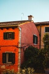 Colorful facade of traditional Italian houses with green shutters
