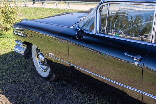 Classic black cadillac coupe deville parked on grass