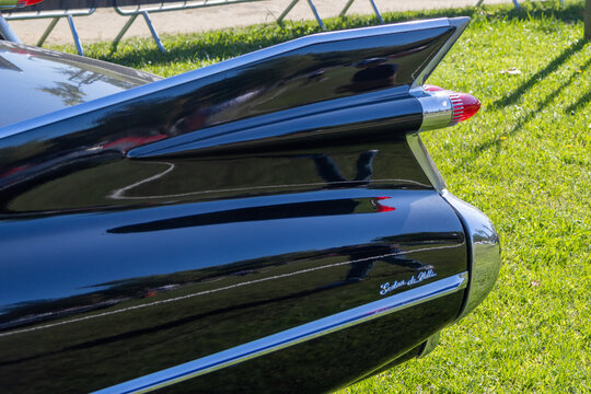 Black cadillac coupe deville reflecting grass and sky