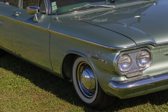 Chevrolet corvair parked on grass at car show