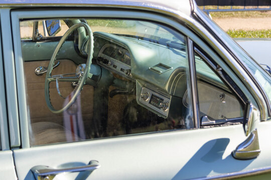 Classic chevrolet corvair dashboard interior showing steering wheel and radio
