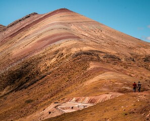 Hikers on the slopes of Rainbow Mountain in Peru.