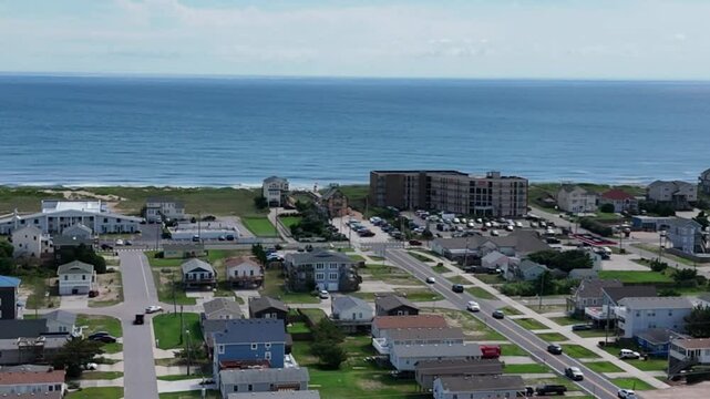 Aerial footage of the urban buildings overlooking the Atlantic Ocean in Kill Devil Hills, NC, USA