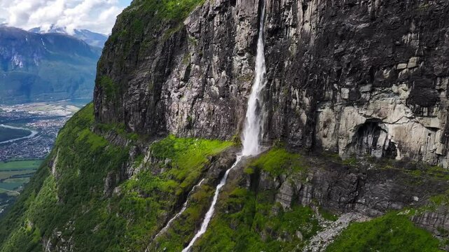 Drone slow-motion of the Seven Sisters Waterfall flowing on mountain along the Geirangerfjorden