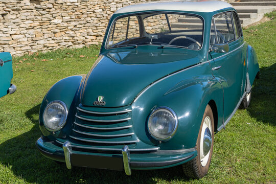 Auto union dkw f91 parked on grass in front of stone wall