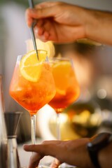 Closeup of two glasses filled with Aperol Spritz cocktails