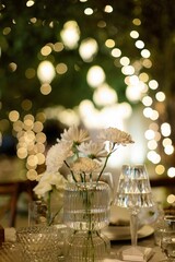 Elegant floral arrangements with white flowers in vases on a table in a wedding venue