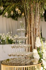 Elegant champagne glass tower setup at a wedding reception