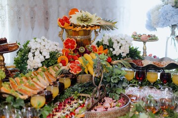 Vibrant fruit and flower display at an elegant event