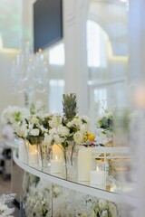 Elegant wedding table setting with white flowers and candles.