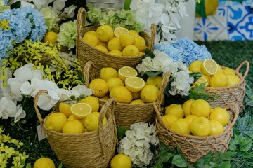 Baskets of lemons with vibrant flowers.