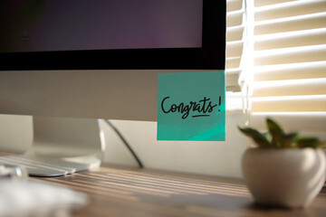 Sticky Notes with Congratulation Text on Computer
