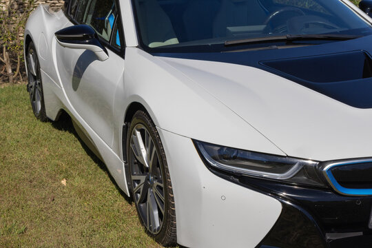 Bmw i8 white luxury hybrid car parked on grass