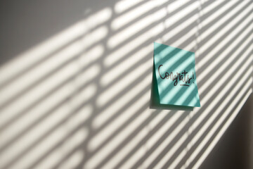 Blue Sticky Notes with Congratulation Text on Wall