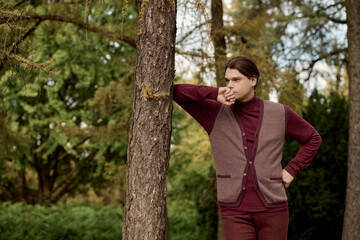 Handsome male model engaging with serene natural surroundings.