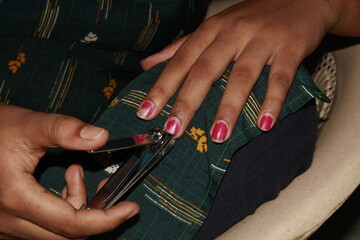 Cutting nails using nail clipper, Concept of personal hygiene and healthcare