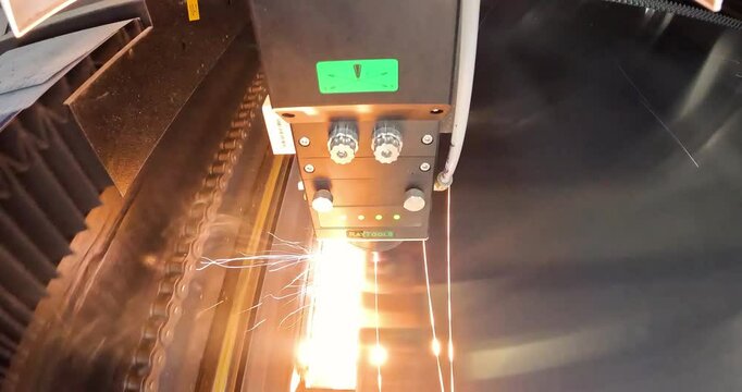 The process of cutting a metal part with a laser cutter. The laser cutter will cut the part. Laser cutter Plasma cutter work at the factory.