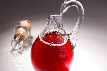 Broken glass bottle with cork on white table, broken structure