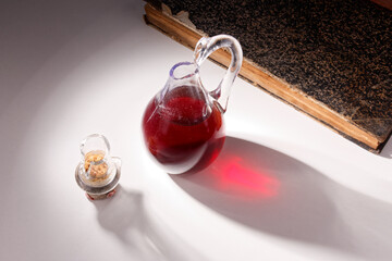 Broken glass bottle with cork on white table, broken structure