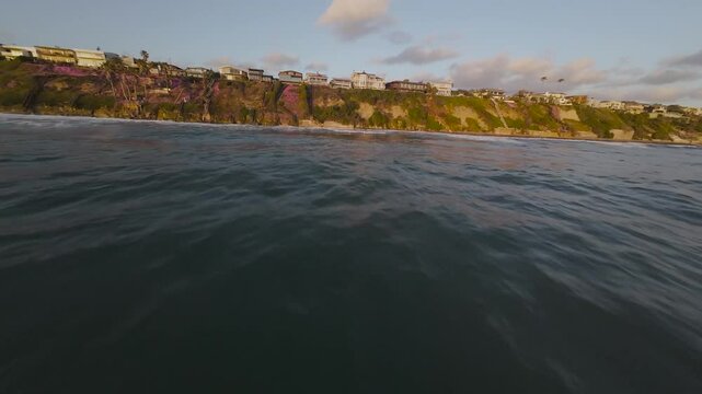 buildings on cliff overlooking the ocean on Moonlight State Beach at sunset in Encinitas, California