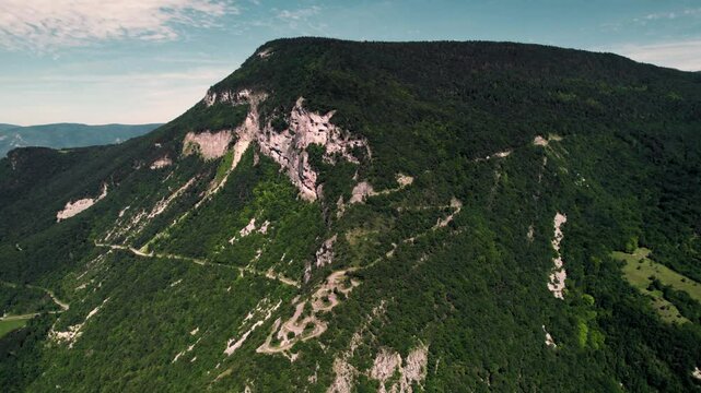 Aerial footage of the scenic green mountains in the town of Culoz in the Ain department, France