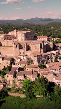 Aerial vertical footage of Grignan commune on a sunny day in the Drome department, France