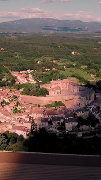 Aerial vertical footage of Grignan commune on a sunny day in the Drome department, France