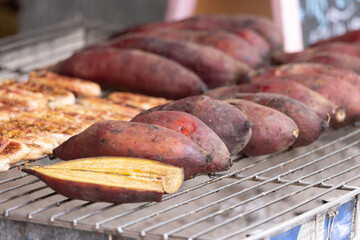 A rack of food with a bunch of potatoes and a piece of meat