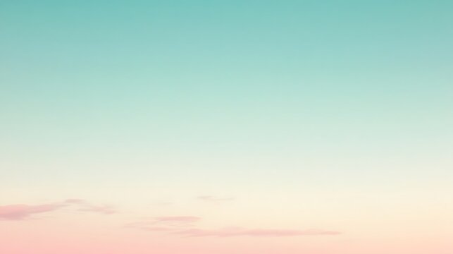 A soft, pastel pink and teal sky with a few wispy white clouds.