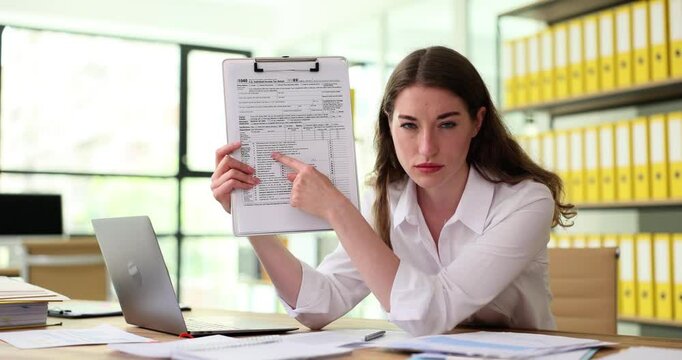 Tax inspector is surprised by the amount of income and shows tax form. Inspectorate of Ministry of taxes and duties concept